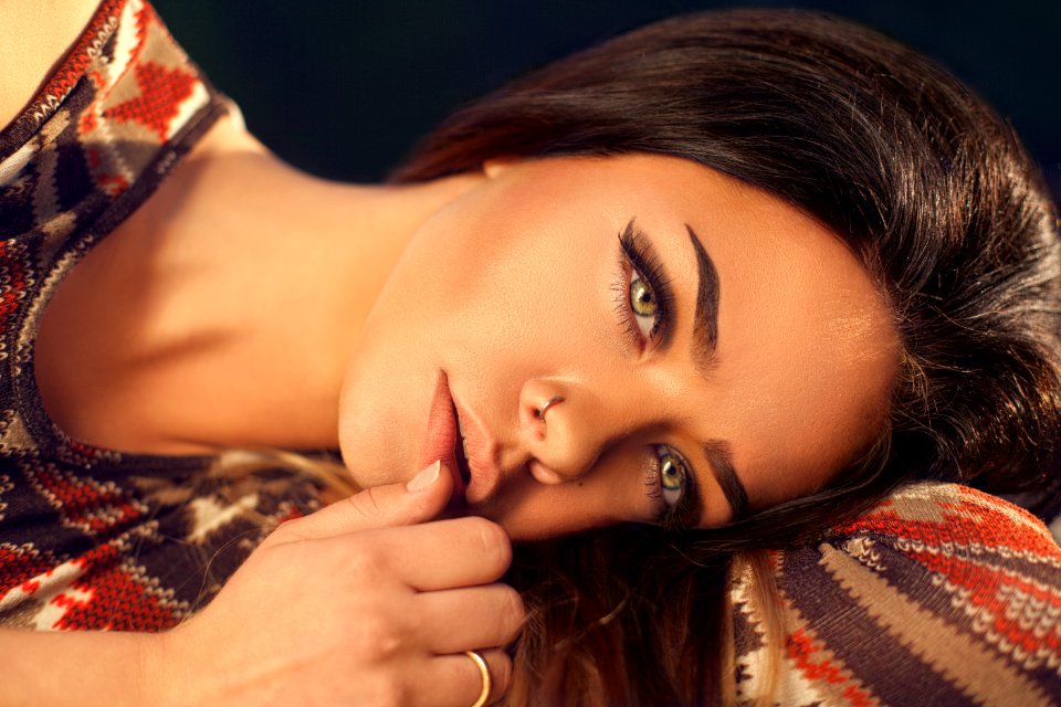 woman wearing red, white, and black aztec top