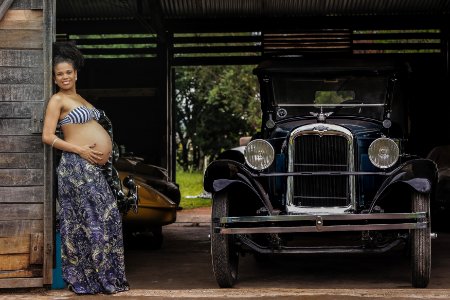 pregnant woman near classic car photo