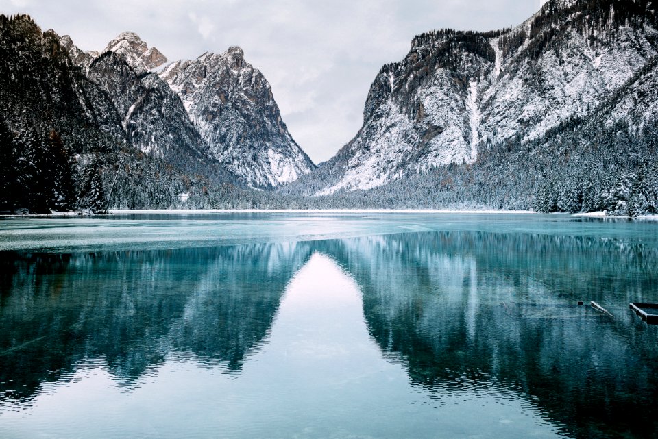 body of water and snow-covered mountains during daytime
