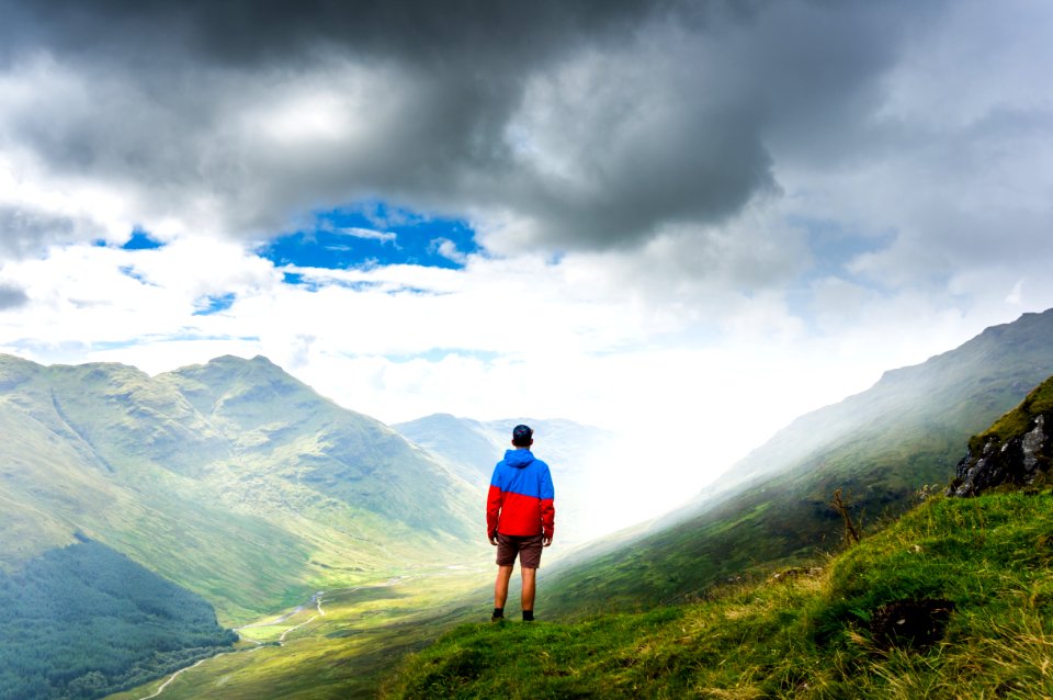 photography of man standing on green grass