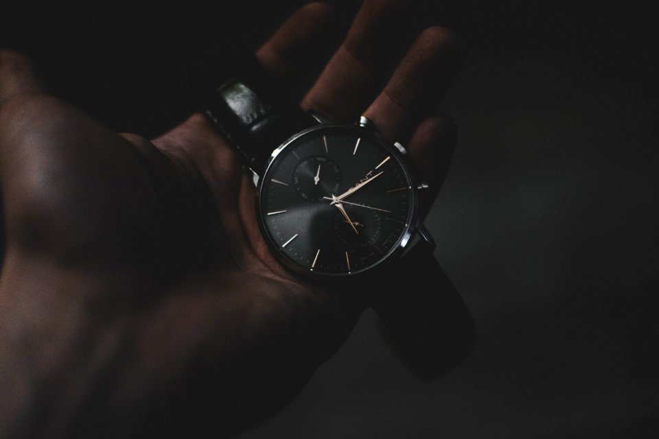 person holding watch pointing at 6:17