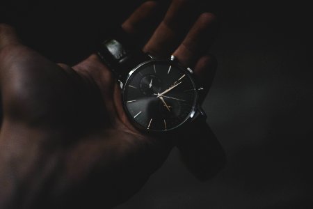 person holding watch pointing at 6:17