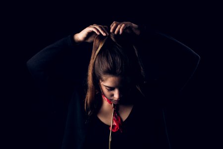 woman tying hair with both hands