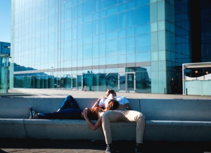 man and woman laying on concrete stairs photo