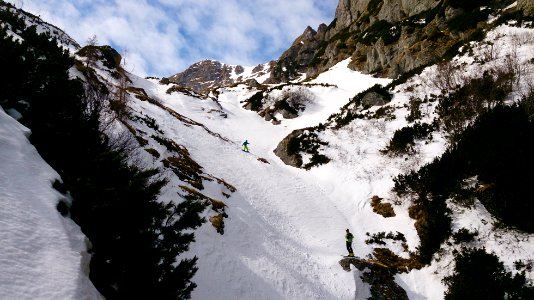person snowboarding on mountain covered with snow