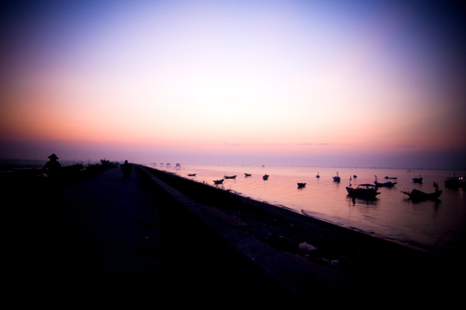 silhouette of boats on shore