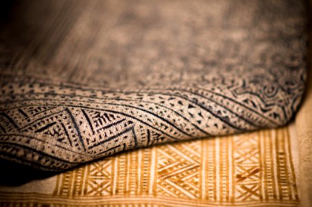 A close up that shows the texture of two different patterned rugs photo