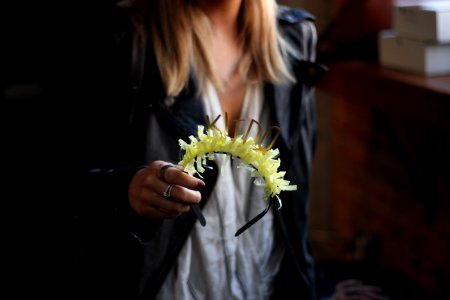 person holding green and black headband