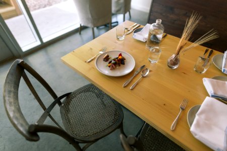white ceramic plate and silver flatware on table photo