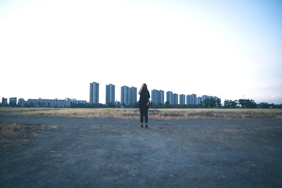 woman wearing black shirt and pants standing on field during daytime
