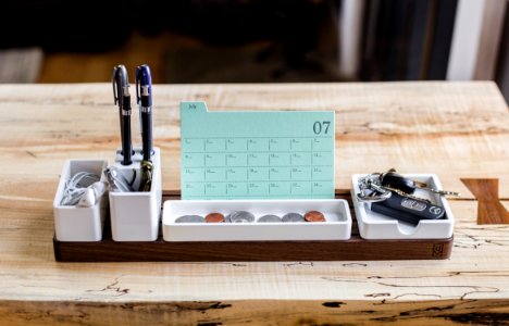coin on tray beside pen organizer on table photo