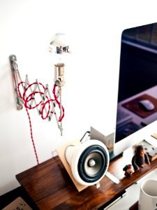 white and black speaker on brown wooden table photo