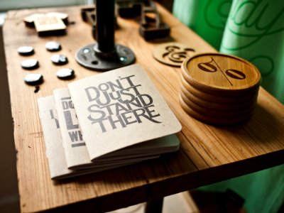 three gray papers near round brown wooden boards on table photo