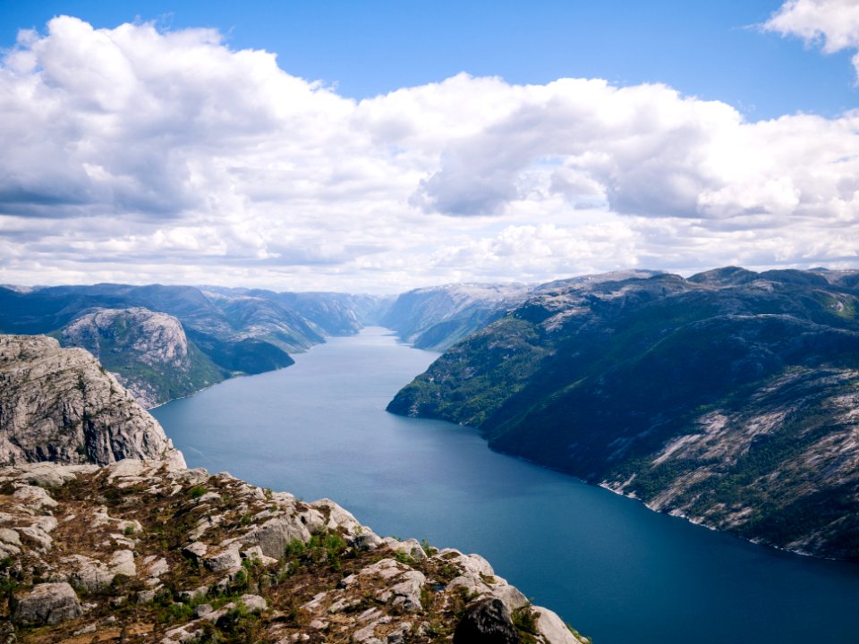 landscape photo of body of water between mountains