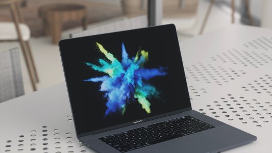 MacBook Pro on white metal surface photo