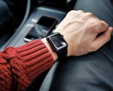 person wearing black case Apple Watch with white Sport Band photo