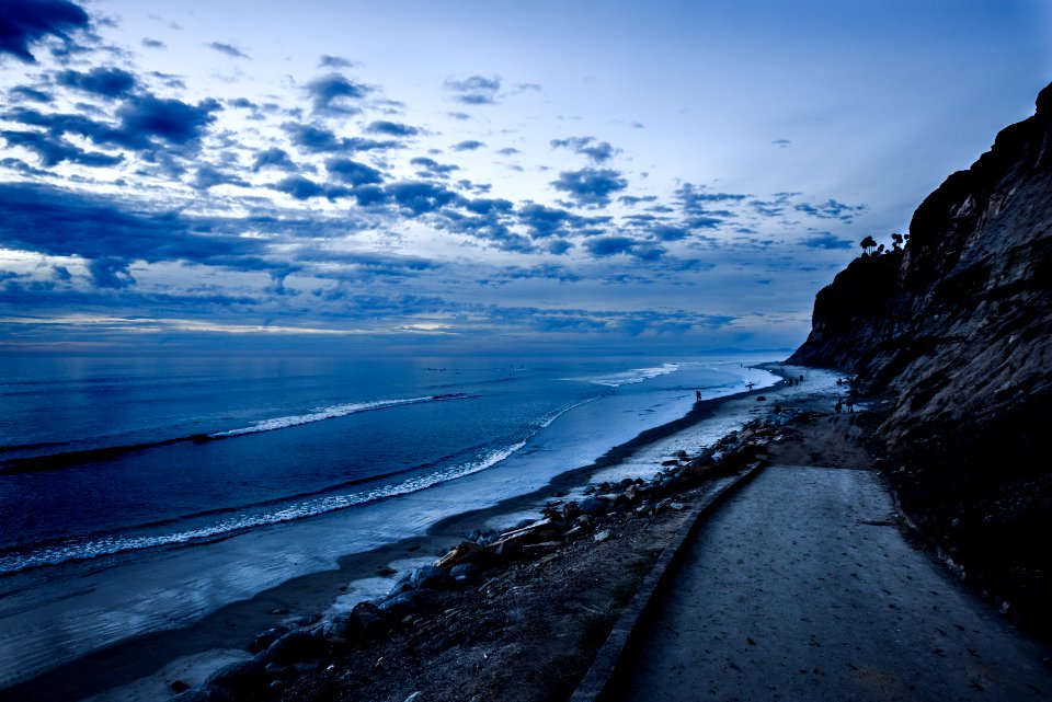roadway near shoreline landscape photography