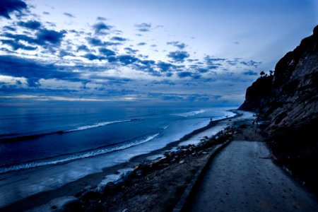 roadway near shoreline landscape photography