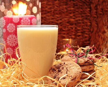 Glass of milk with cookies candles drink photo
