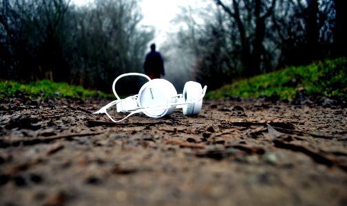 tilt shift lens photography of white corded headphones
