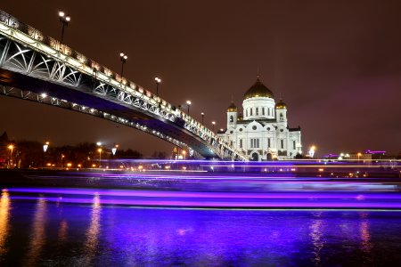 white mosque with bridge during night time photo