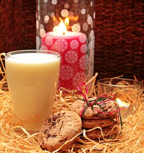 Glass of milk with cookies candles drink photo