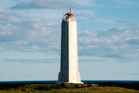 white lighthouse near body of water photo