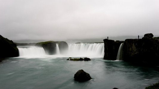 waterfalls under cloudy sky photo