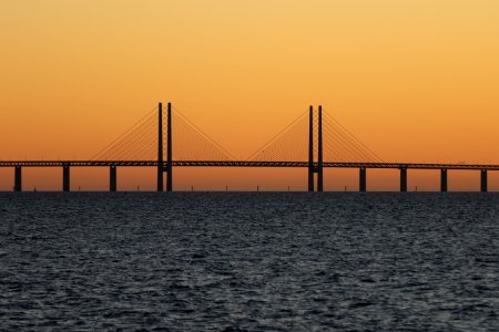 bridge during sunset with body of water photo