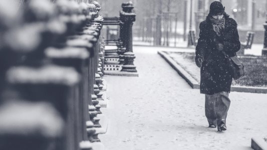 grayscale photo of person walking on street photo