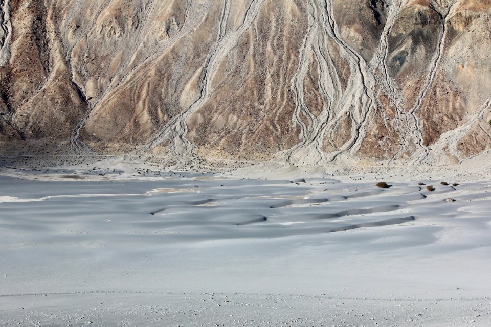 body of water beside mountain