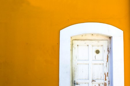yellow wall with white wooden door photo
