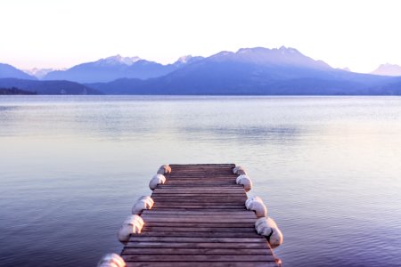 brown wooden boat dock in gray skies background