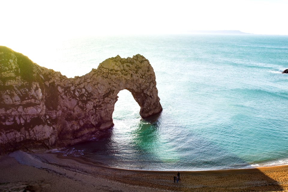 aerial view of beach with arch rock formation