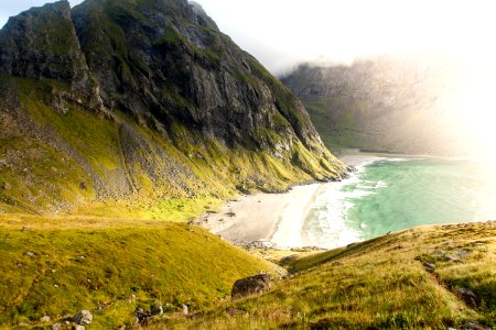 landscape photography of beach surrounded by mountains