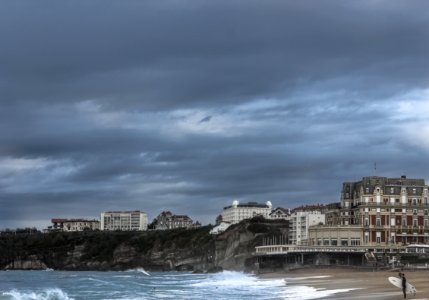 concrete buildings by the sea during daytime photo