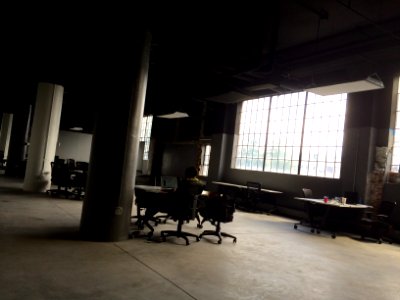 man sitting on chair facing table inside building photo