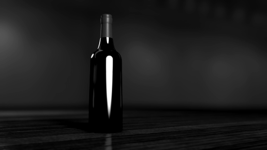 black glass bottle on brown surface
