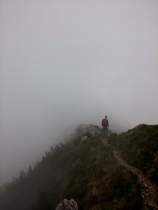 man standing on hill with fogs photo
