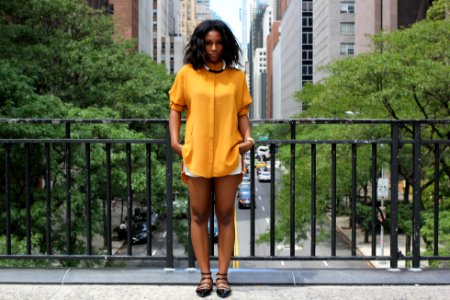 woman standing on brown bridge during daytime photo