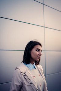 woman in white jacket looking forward photo