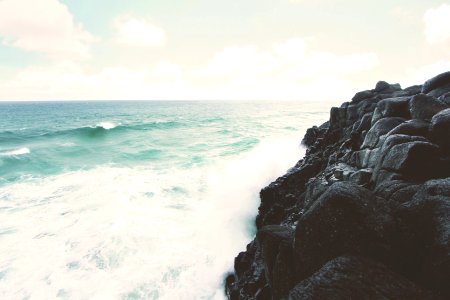 rocky cliff beside the ocean photo