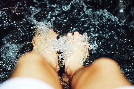 person putting his feet on water