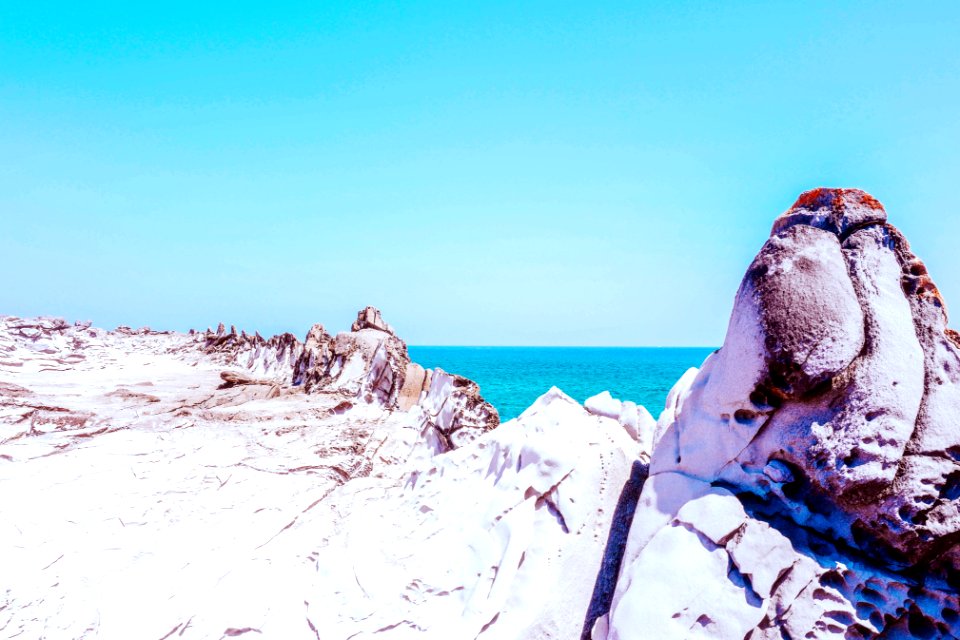 white and gray stone formation near sea at daytime