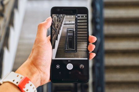 person holding Android smartphone displaying camera