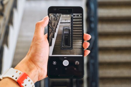 person holding Android smartphone displaying camera photo