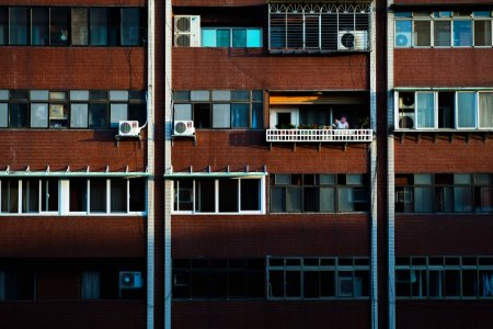 person at the balcony of a building during day photo