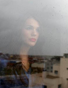 woman looking through window photo