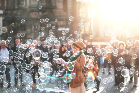 woman standing outdoor surrounded by bobbles during daytime