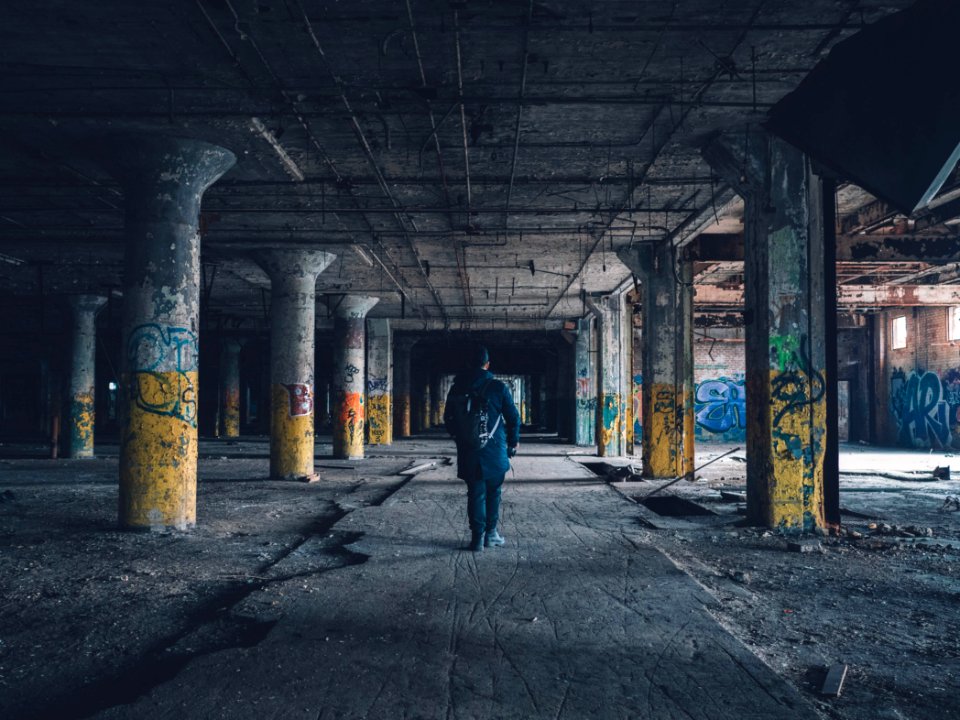 man walking hallway during daytime